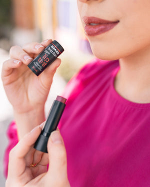 Advertisement for Eco Lips with text about stocking stuffers on a festive background.