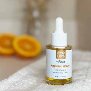 Woman holding out bottle of morning serum showing the 5% Vitamin C