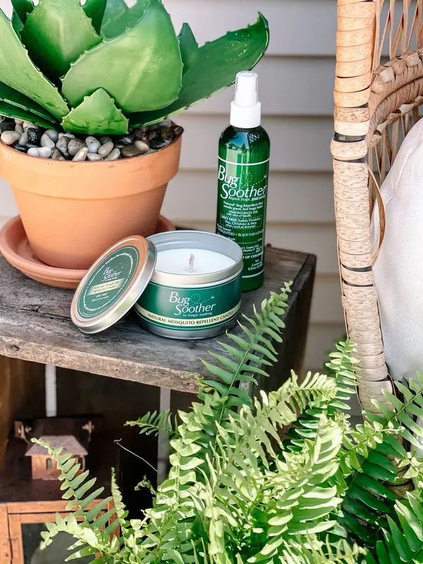 Advertisement for Bug Soother natural bug repellent with two bottles shown on a wooden surface