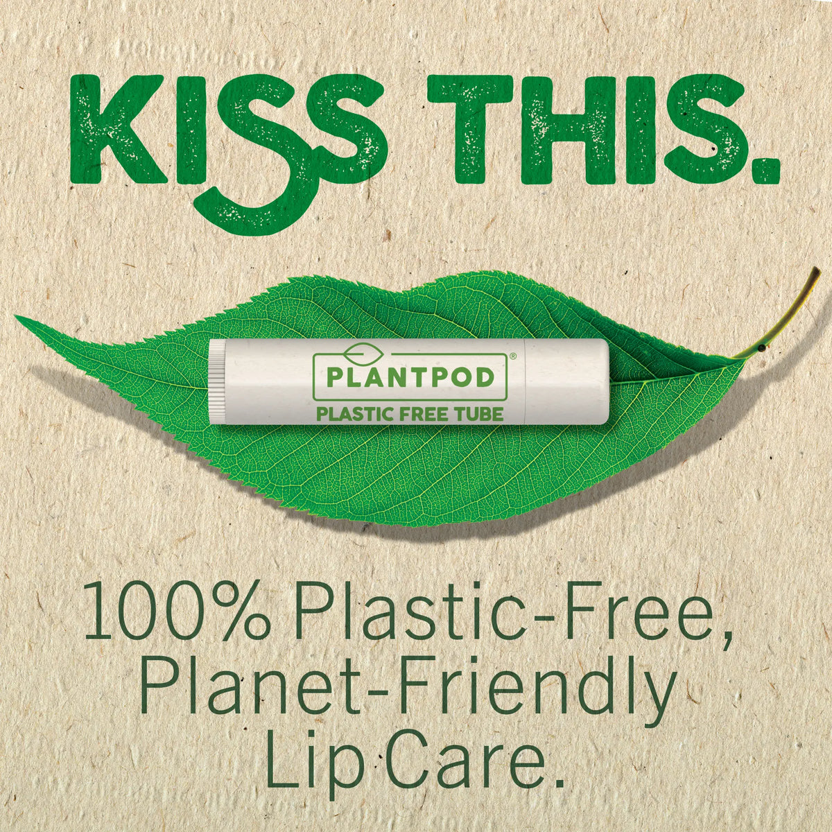Plantpod plastic-free lip balm on a leaf with 'Kiss This' text on a beige background