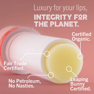 Lip balm with certification labels on a pink background