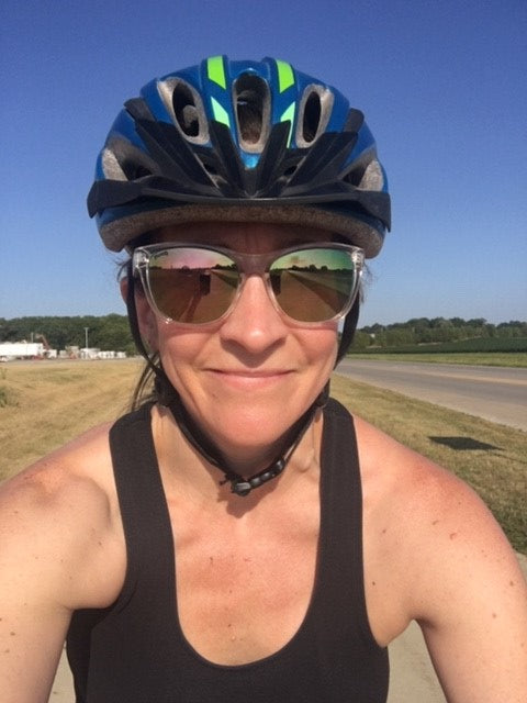 Woman wearing bicycle helmet and sunglasses, enlarge image