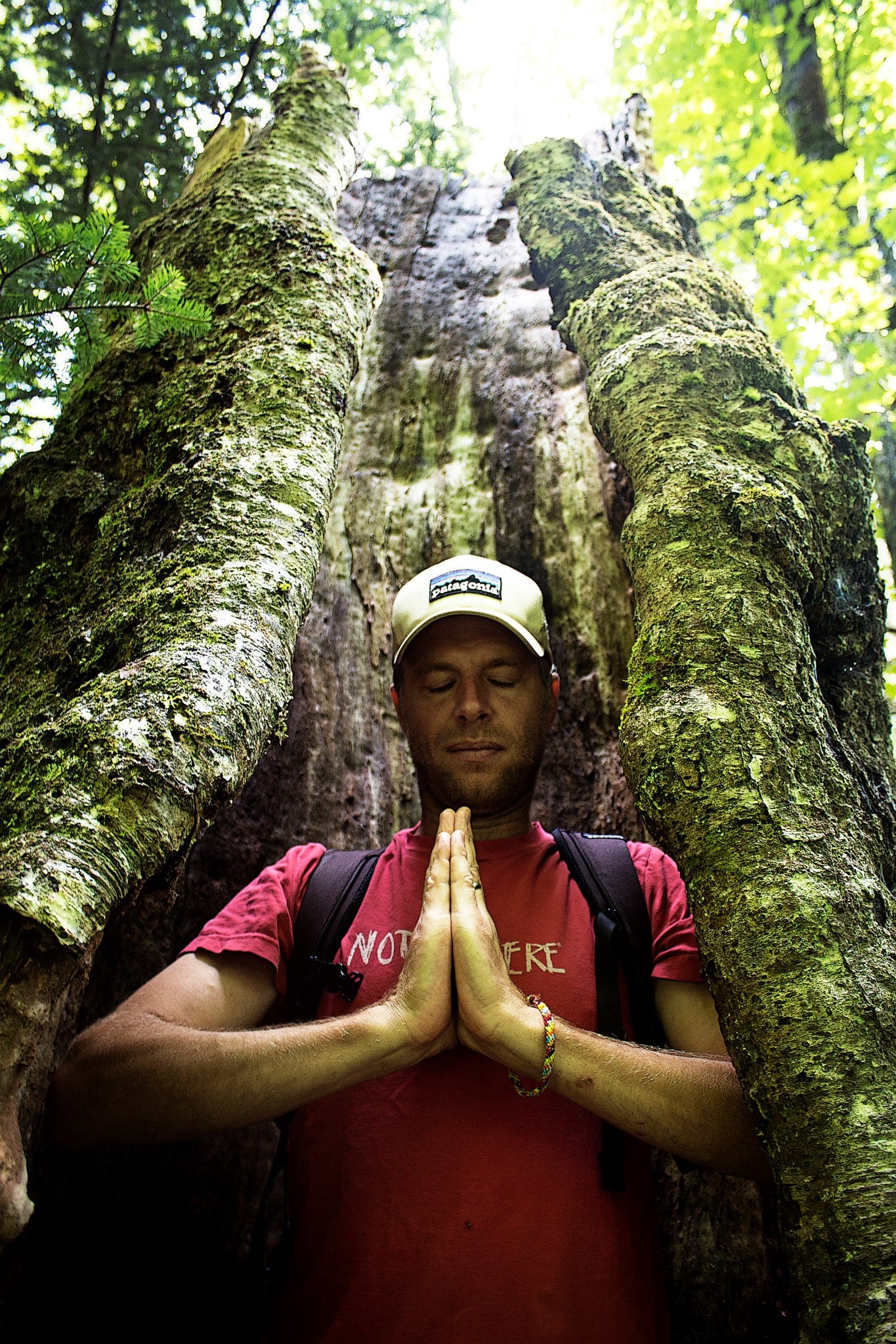 Man meditating next to rock formation, click to enlarge