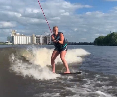 woman wake boarding on a river, enlarge image