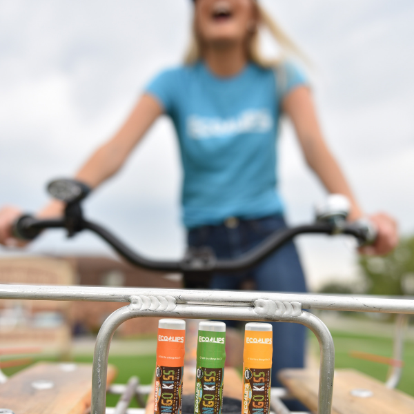 Woman standing with bicycle and Eco Lips Mongo Kiss in the bicycle basket, enlarge image