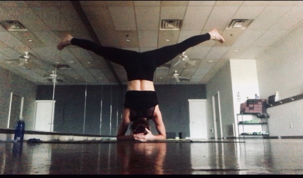 Woman performing yoga headstand, enlarge image