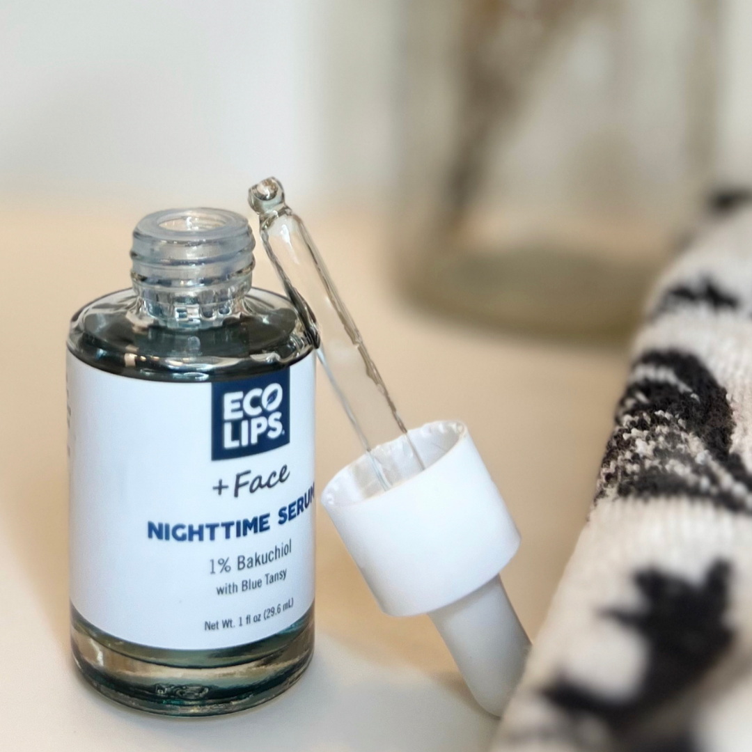 A bottle of Nighttime serum is displayed with the dropper cap leaning against the bottle. 